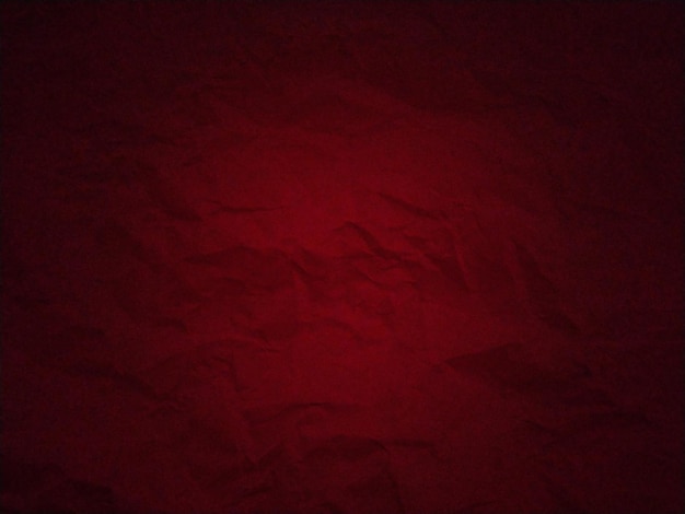 Premium Photo  Dark red background with uneven spots and vignetting  crumpled thick paper texture blood red color dark frame around the edges