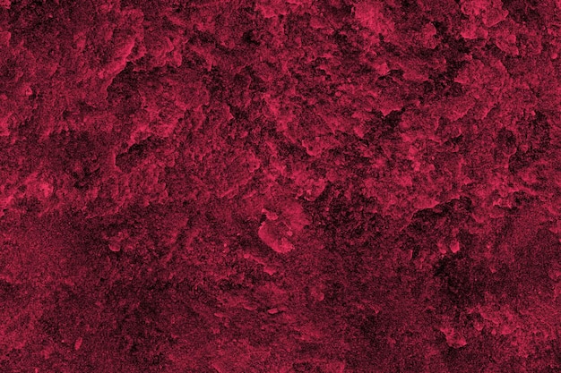 Dark red color rough concrete wall surface with heavy grunge texture