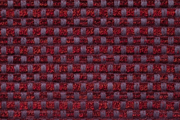 Dark red from checkered pattern textile, closeup. Structure of the wicker fabric macro.