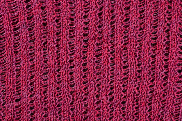 Photo dark red openwork stockinet as background texture