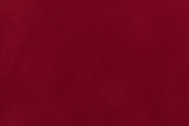 Photo dark red suede fabric closeup. velvet texture background