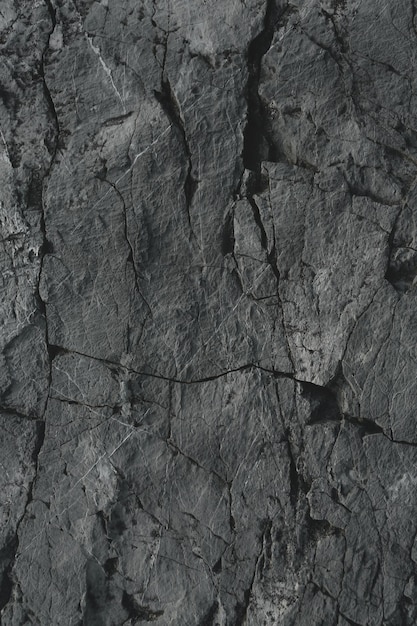 Foto sfondo texture roccia scurascuro invecchiato e incrinato di pietra nera