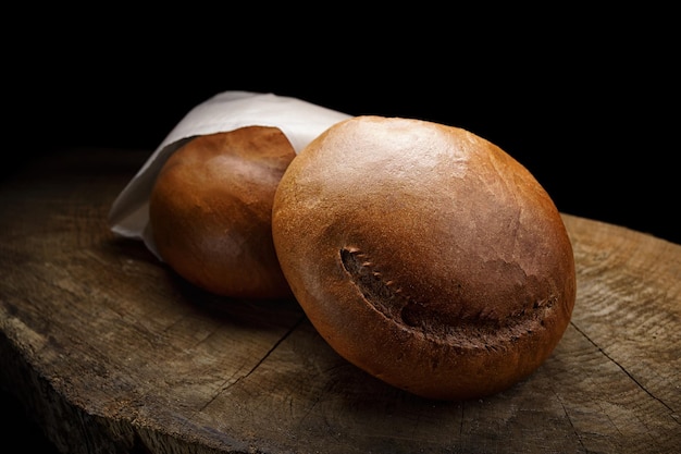 Dark round bread on a wooden board