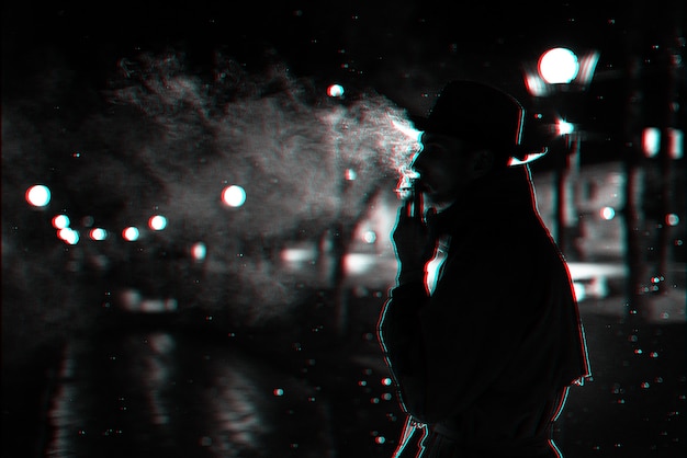 Dark silhouette of a man in a hat smoking a cigarette in the\
rain on a night street. black and white with 3d glitch virtual\
reality effect