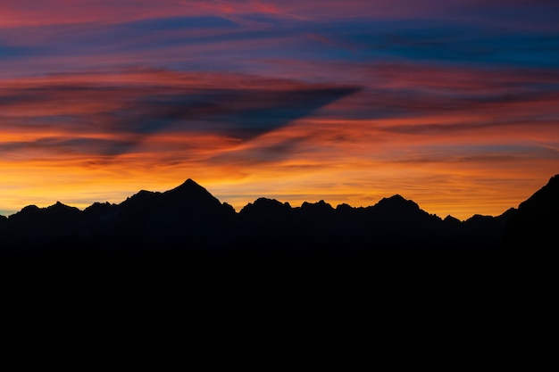 Dark Silhouette of Mountains and sunset Mountain peaks Dolomites Brenta Italy