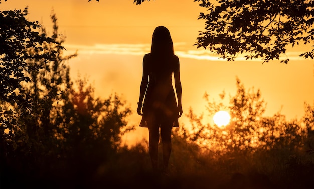 Silhouette of a woman enjoying herself in nature