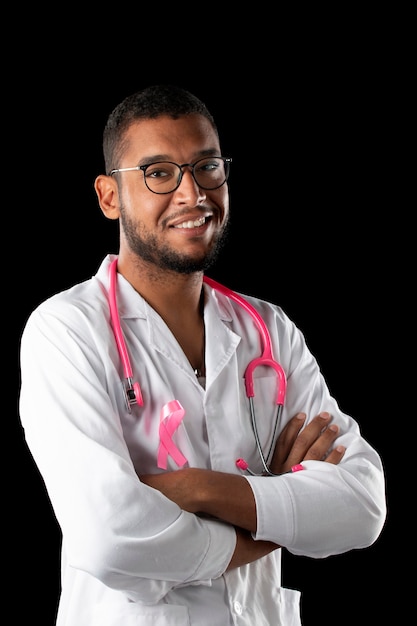 Dark skin doctor with pink stethoscope and pink awareness breast cancer ribbon 