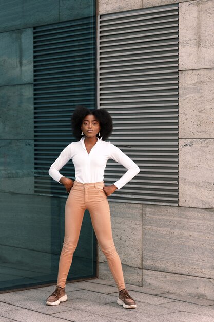 Dark-skinned woman near the blue gray wall