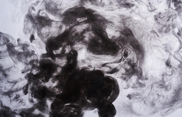 Dark smoke on white ink background colorful fog abstract swirling ocean sea acrylic paint pigment underwater