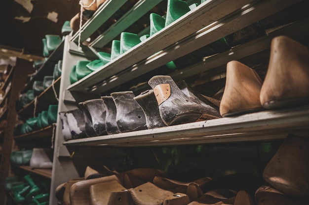 Dark storage with shelves and many forms for creating different shoes and boots.