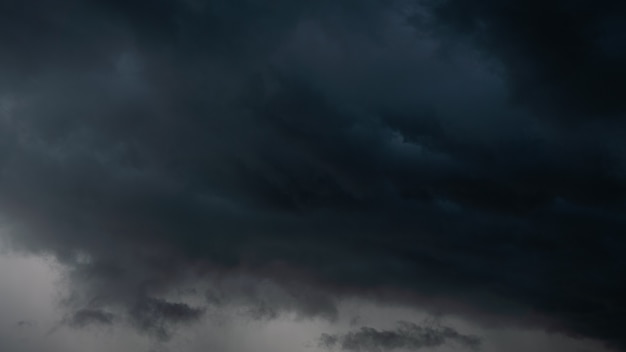 Dark storm clouds make the sky in black. the rain is coming\
soon. beautiful heaven with dramatic light, sometimes heavy clouds\
mass charged. abstract nature background.