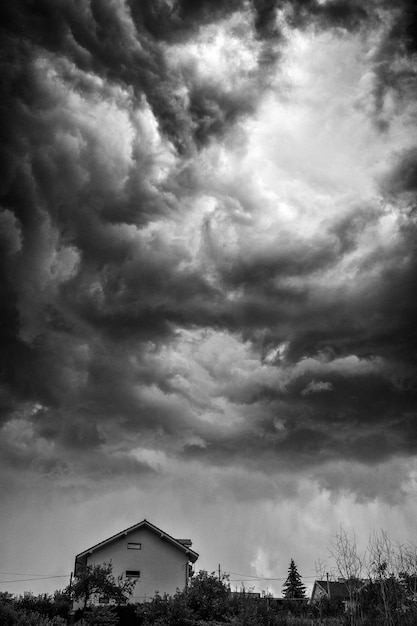 Dark stormy clouds over house