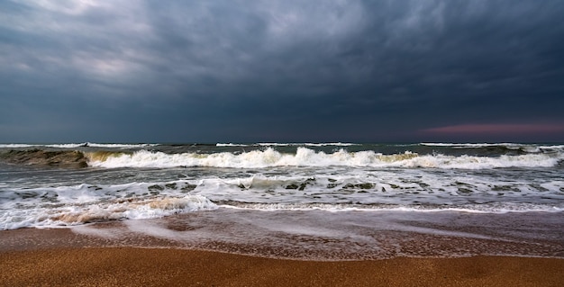 Dark stormy sea and empty beach