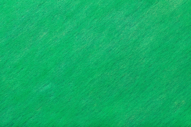 Photo dark turquoise matt suede fabric background. velvet texture of felt.