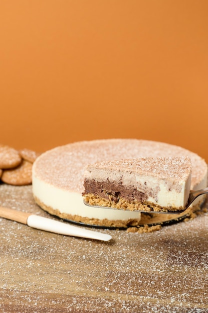 Dark and white chocolate cake with cookies on orange background