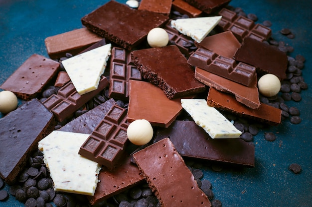 Dark, white and milk chocolate pieces. Top view