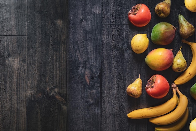 Dark wood background with fruits Banner for fruit shops, supermarkets Healthy gastronomic background