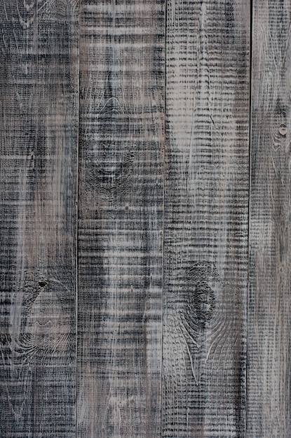 Dark wooden background made of a wide board, painted in dark brown .