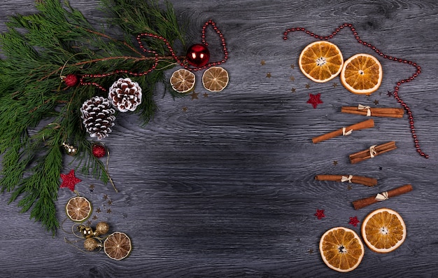 A dark wooden background with Christmas decor and copy space for text