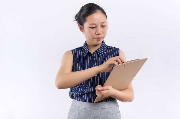 Darkhaired woman in knitted sweater looks up thoughtfully Lady thinks what to write in new book