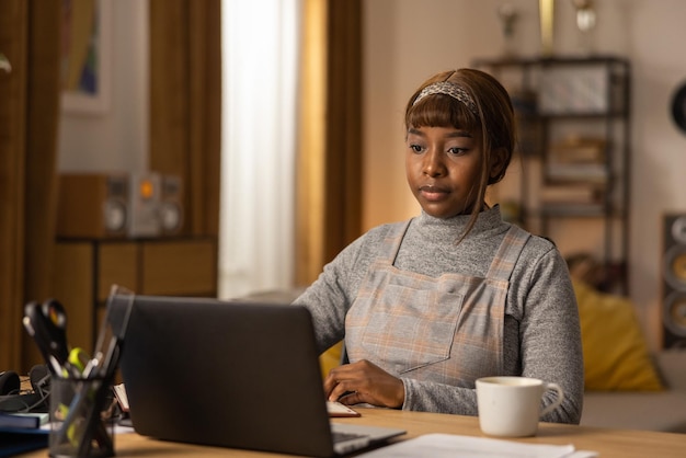 A darkskinned girl prepares for an online meeting at her company