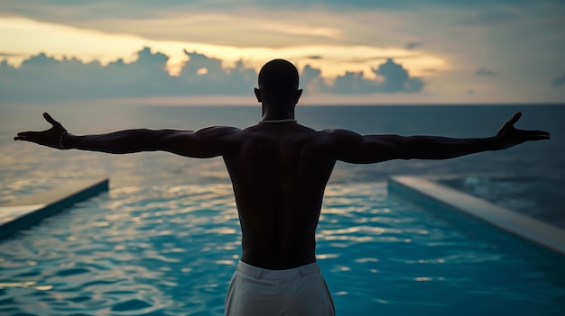 darkskinned man embracing the vast blue ocean at sunset arms outstretched