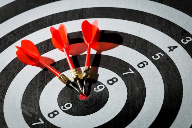 Dart arrow hitting in the target center of dartboard. concept of the success