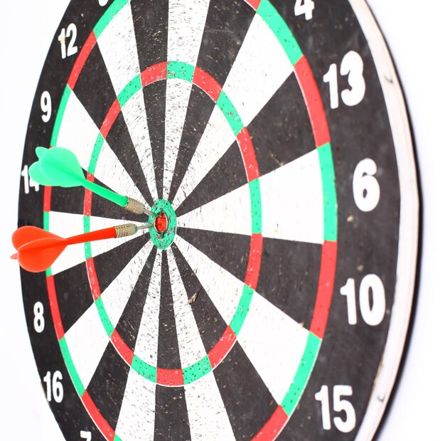 Dart board with a dart in the center of the target