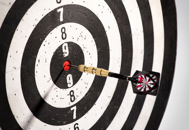 Dart in the bulls eye center of a dart board