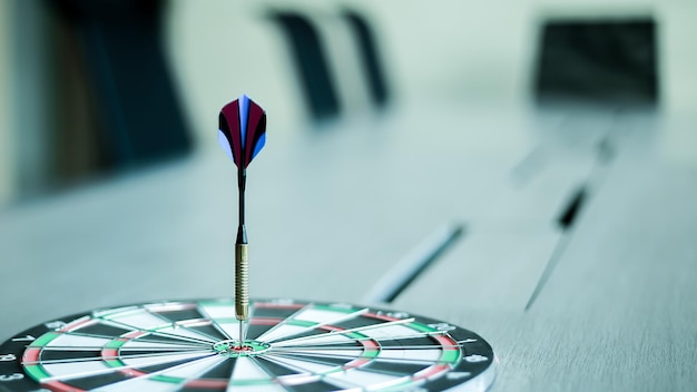 The dart hits the center of the dartboard as a business goal