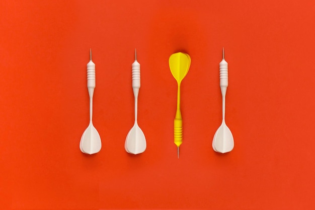 Dart on a red background top view flat lay