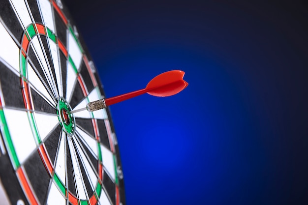 Darts arrows in the target center on blue