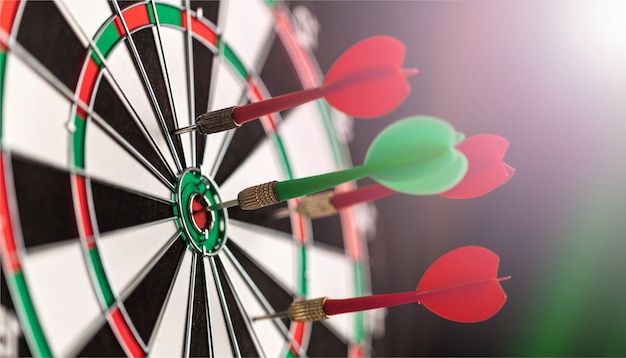 Darts in bulls-eye close up, purpose concept