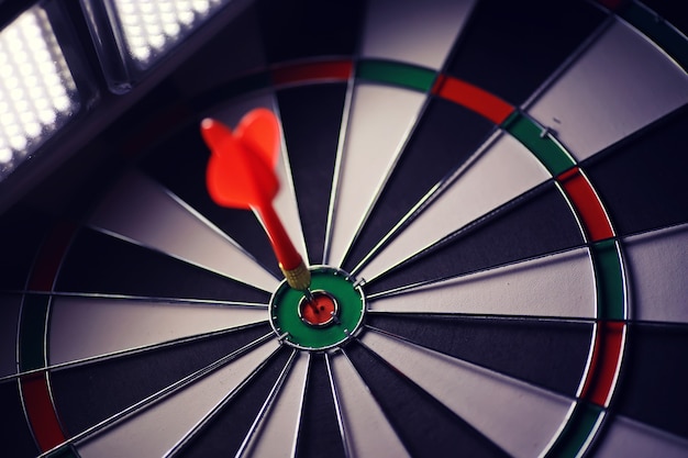 Darts. The dart for playing in the game board is stuck. Hit the sector in darts. The concept of a successful strategy.