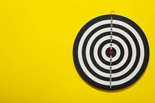 Darts hitting the target with wires on a yellow background