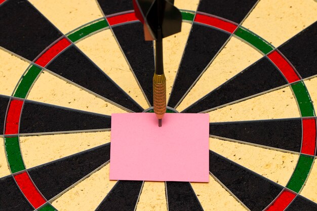 Darts with dart arrow which was pinned a sheet of paper for labels