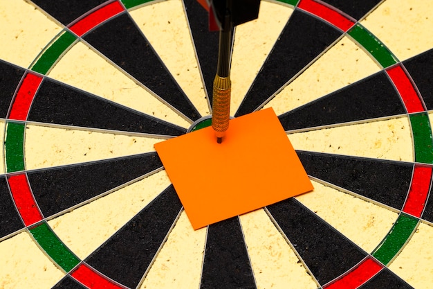 Darts with dart arrow which was pinned a sheet of paper for labels