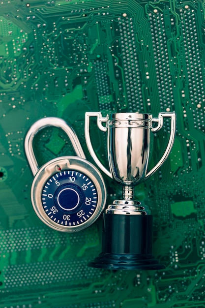 Data security expert padlock and trophy on a computer\
electronic circuit board