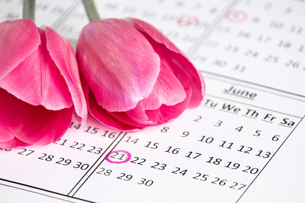 Photo date on the calendar. international flower day. holiday solstice and the first day of summer