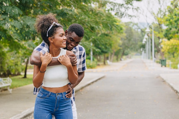 Photo date couple man and women valentine day african black lover at park outdoors summer season