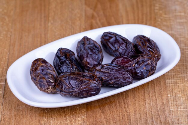 Date fruit Naturally date palm fruit in a ceramic bowl Ramadan food Close up