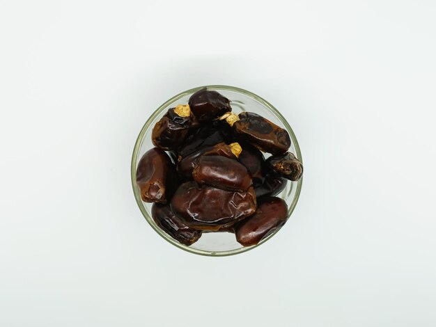 Photo date palm fruit isolated on white background dried dates in glass bowl