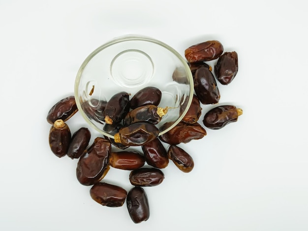 date palm fruit isolated on white background dried dates in glass bowl