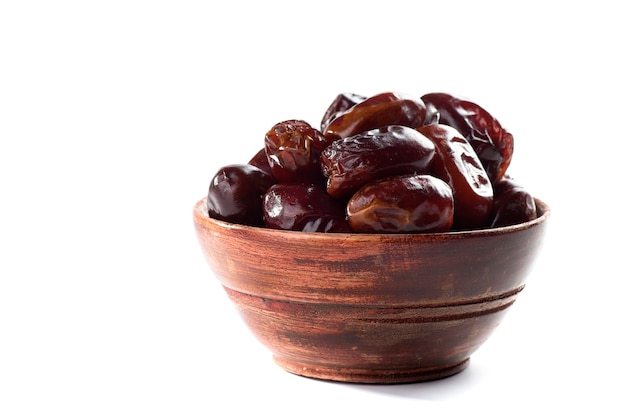 Dates in bowl on a white background. dried dates fruit.