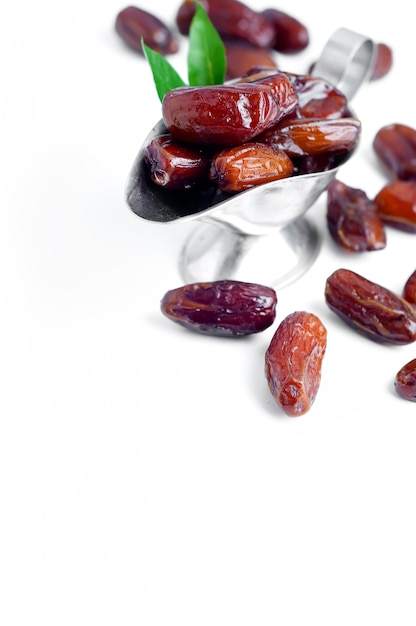 Dates in a bowl on white background.