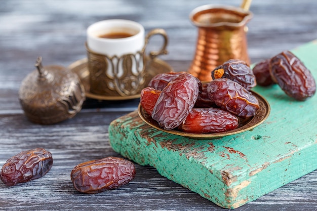 Dates on a bronze plate and black coffee