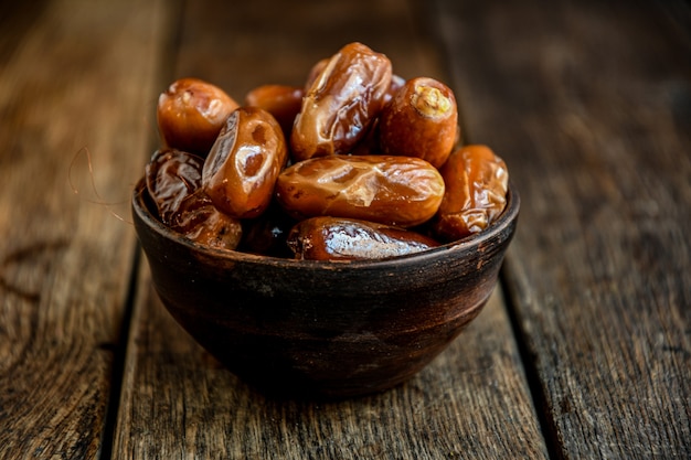 Dates in ceramic dishes on a wooden table