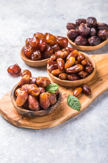 Dates or dattes palm fruit in wooden bowl is snack healthy.