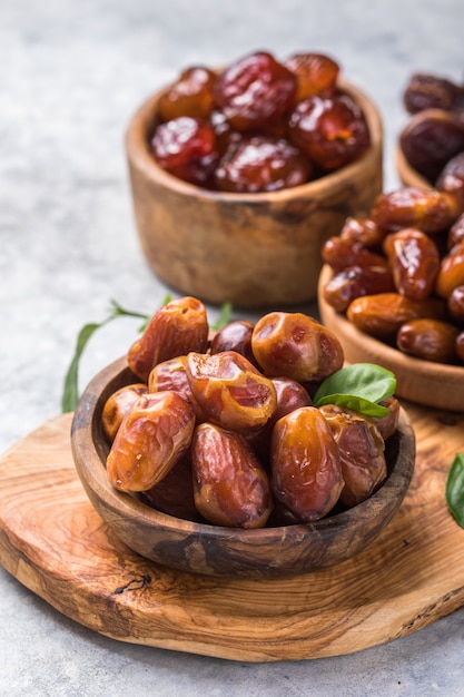 Dates or dattes palm fruit in wooden bowl