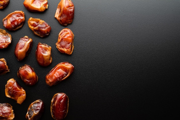 Dates fruit on dark background with copy spaces. Arabian fruit. Ramadhan season.